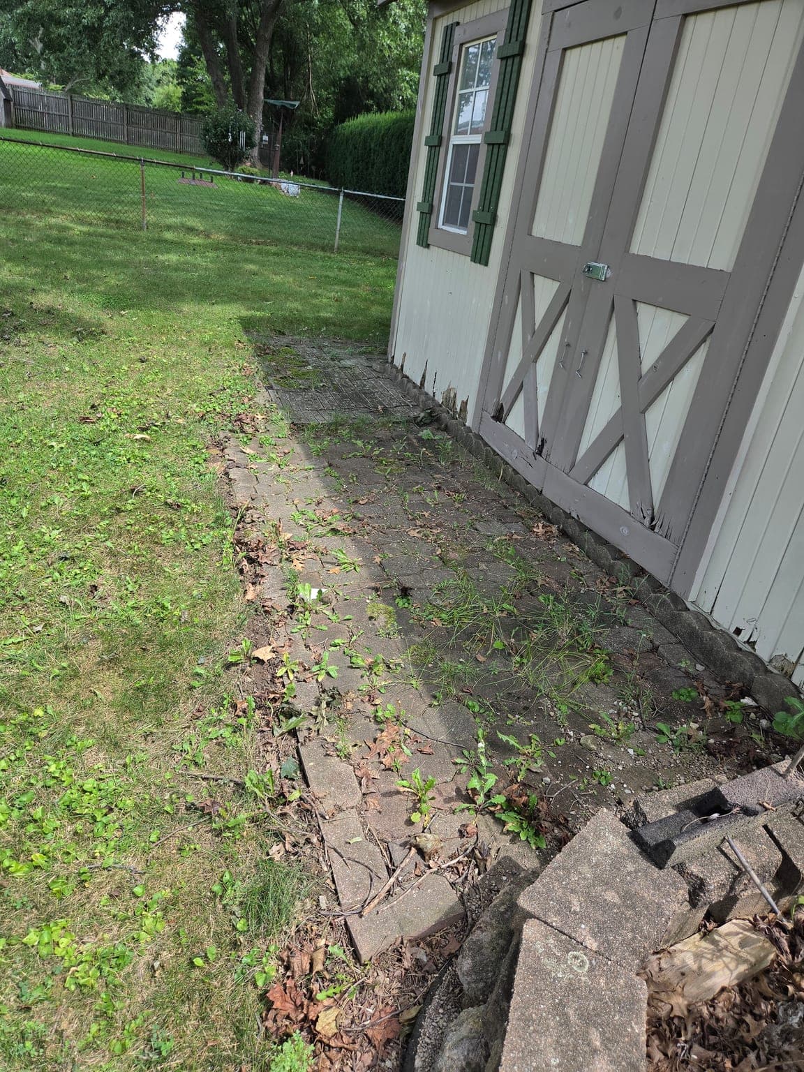 Before rear building pavers. oil stain treatment in Canton, OH - SurfaceWorks ProWash